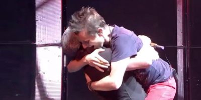 Matt Bellamy hugs Brian Johnson onstage