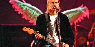 Kurt Cobain live onstage, with angel wings behind him