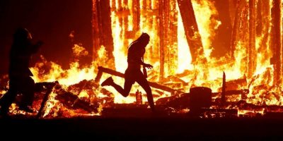 A man runs into the flames at Burning Man festival