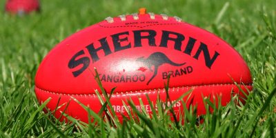 Image of a Sherrin footy lying in the grass