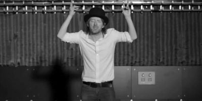 A screenshot of Thom Yorke dancing from the film clip to Radiohead's 'Lotus Flower'