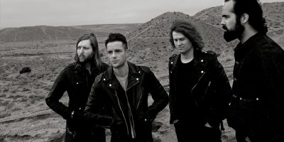 Black and white image of US rock band The Killers in a desert