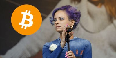 Lily Allen staring wistfully at the logo for cryptocurrency Bitcoin