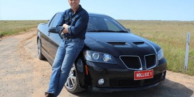 Aussie music legend Shannon Noll, standing by his car.