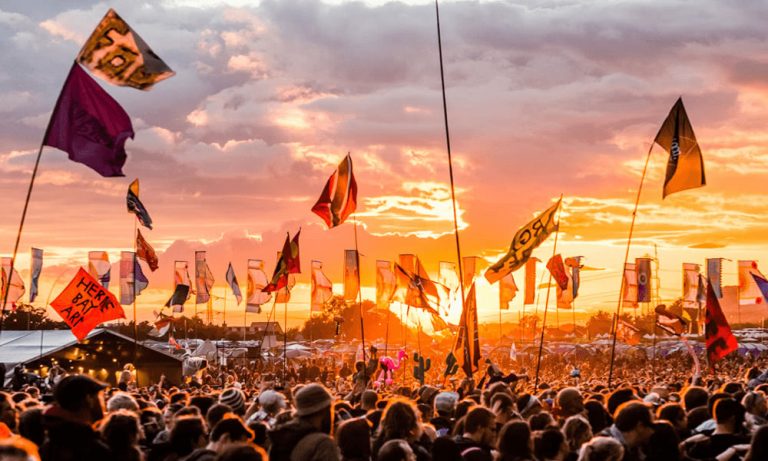 The crowd at Glastonbury festival at sunset