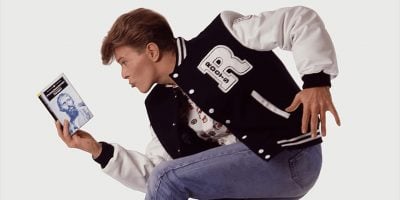 David Bowie, reading a book in a rather cheesy promotional photo