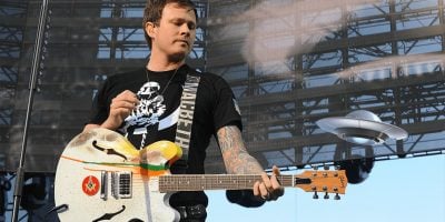 Former Blink-182 guitarist Tom DeLonge pictured with a fake UFO.