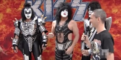 Screenshot of an interview in which KISS force an interviewer to remove his Iron Maiden shirt