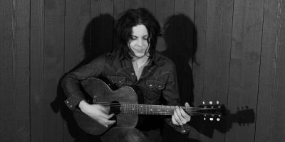 Blues-rock legend Jack White playing acoustic guitar