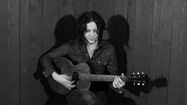 Blues-rock legend Jack White playing acoustic guitar