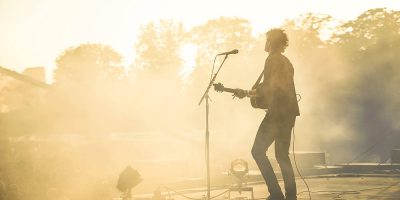 Vance Joy on a sunlit stage, shot by Brad Cauchy