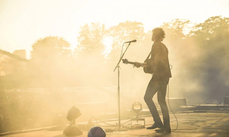 Vance Joy on a sunlit stage, shot by Brad Cauchy