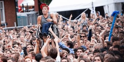 Image of triple j presenter and Paralympian Dylan Alcott crowd-surfing