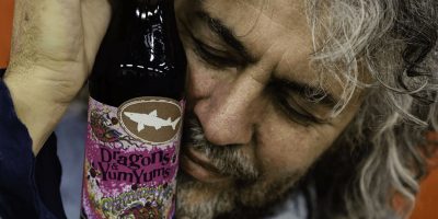 The Flaming Lips' Wayne Coyne with a bottle of Dogfish Head's Dragons & YumYums beer
