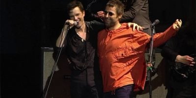 Liam Gallagher appearing onstage with The Killers at Lollapalooza in Brazil