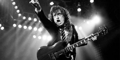 Angus Young of AC/DC playing guitar