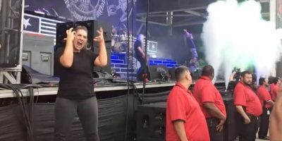 A sign language interpreter translating at a Lamb Of God gig in the US