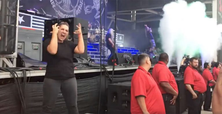 A sign language interpreter translating at a Lamb Of God gig in the US