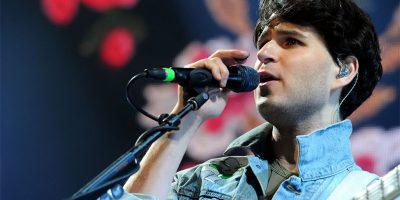 Vampire Weekend's Ezra Koenig performing live