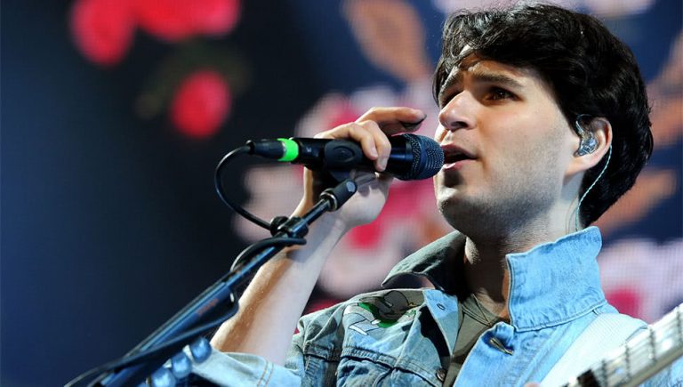 Vampire Weekend's Ezra Koenig performing live