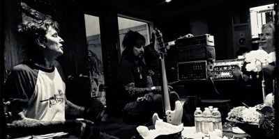 Members of Mötley Crüe in thr studio with producer Bob Rock