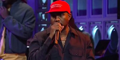Kanye West performing while wearing a 'Make America Great Again' hat