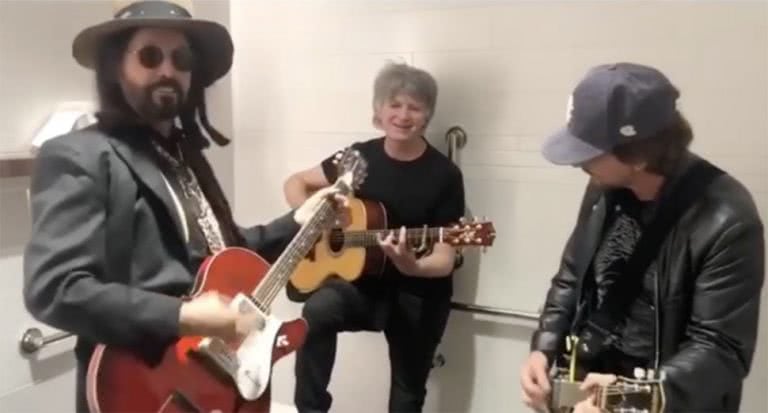 Eddie Vedder jamming out with Mike Campbell and Neil Finn