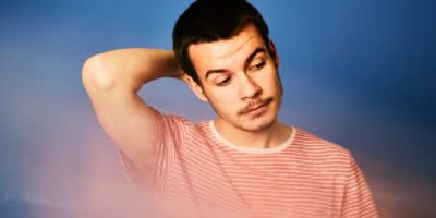 REX ORANGE COUNTY red striped shirt blue background