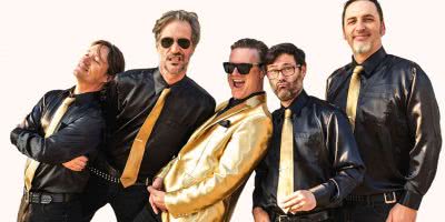 San Francisco punk rockers Me First And The Gimme Gimmes, with frontman Spike Slawson in the middle