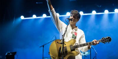 Vampire Weekend frontman Ezra Koenig performing live