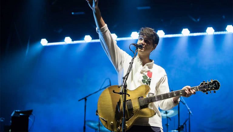 Vampire Weekend frontman Ezra Koenig performing live