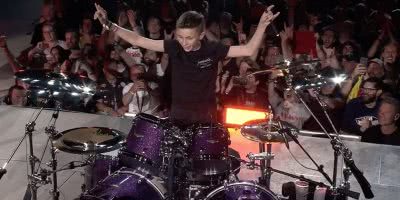 Image of 13-year-old Evan Adamson sitting in as the drummer for Metallica in Amsterdam