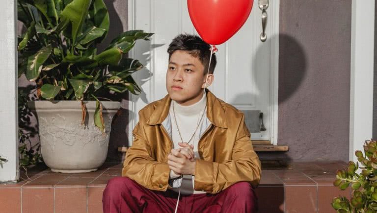 rich brian holding balloon