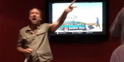 Image of Nicolas Cage performing Prince's 'Purple Rain' at a karaoke bar