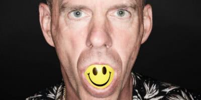 fatboy slim with smiley face in mouth