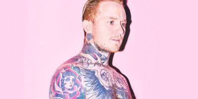 Portrait of Frank Carter in front of a pink background