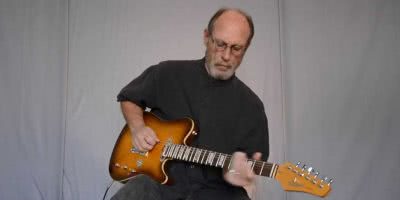 Image of Paul Barrere of Little Feat playing guitar