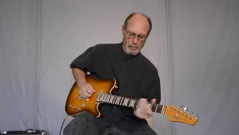 Image of Paul Barrere of Little Feat playing guitar