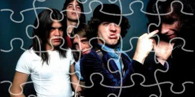 Iconic rockers AC/DC with a puzzle pattern over them.