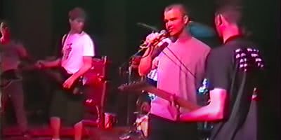 Photo of Zack de la Rocha performing with Hard Stance in March 1990