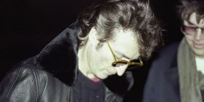 Photo of John Lennon signing and autograph for Mark Chapman