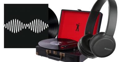 An arctic monkeys record, a record player and headphones