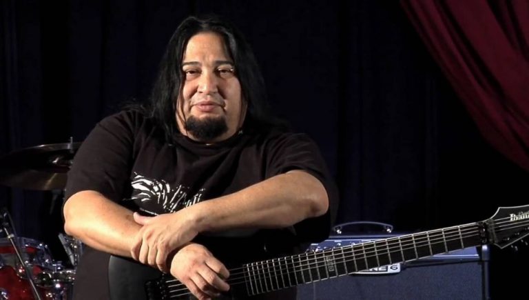 Fear Factory guitarist Dino Cazares holding a guitar