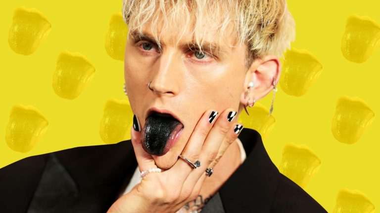 Machine Gun Kelly with a black tongue