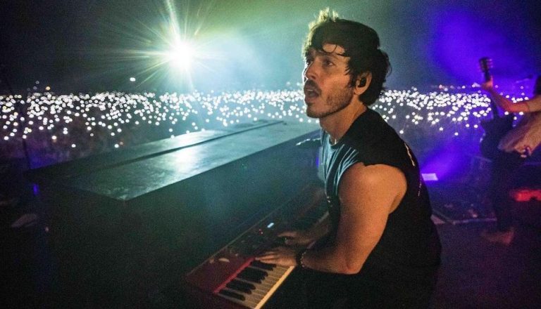 Morgan Evans behind a piano