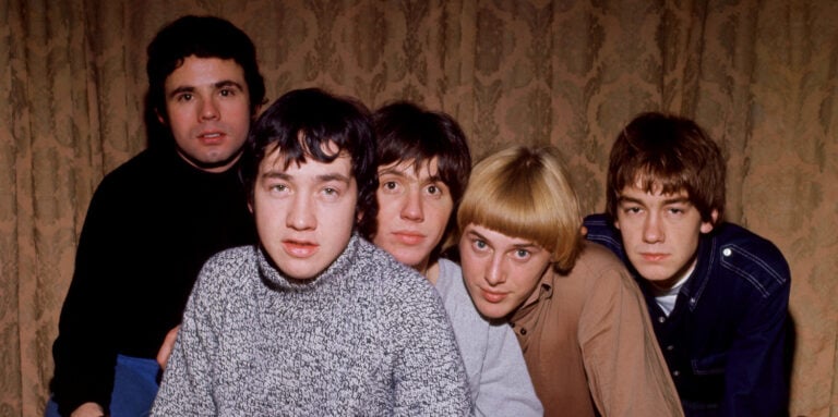 LONDON, ENGLAND - 1966: (L-R) English drummer Snowy Gordon Fleet, Australian musician, songwriter and record producer George Young (1946-2017), English-born musician and songwriter Little Stevie Wright (1947-2015), Dutch Australian musician, songwriter and record producer Harry Vanda and Dutch Australian bass guitarist Dick Diamonde of the Australian rock band The Easybeats joke around with a barrel as they pose for a studio portrait circa 1966 in London, England. (Photo by Jeff Hochberg/Getty Images)