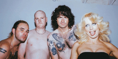 Amyl and the Sniffer band mates posing for the camera