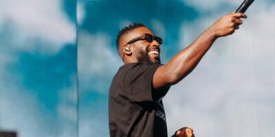 Tinie Tempah on stage with a mic in his hand