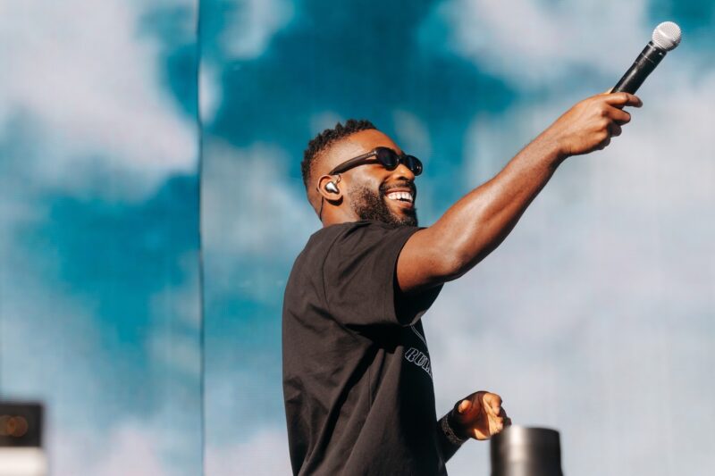 Tinie Tempah on stage with a mic in his hand