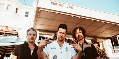 Eskimo Joe posing in front of a venue